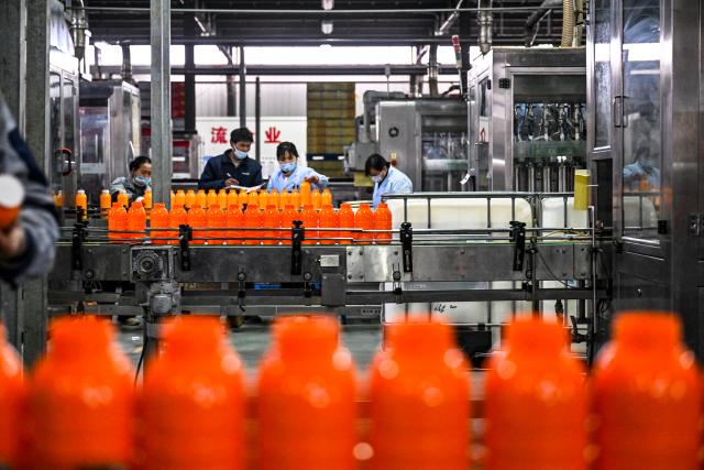 (260224) -- BEIJING, Feb. 24, 2026 (Xinhua) -- Workers work on the herbicide filling production line of a company in Suiyang District, Shangqiu City, central China's Henan Province, Feb. 24, 2026. Factories and companies across China resumed work after the Spring Festival holiday on Tuesday. (Photo by Li Heng/Xinhua)