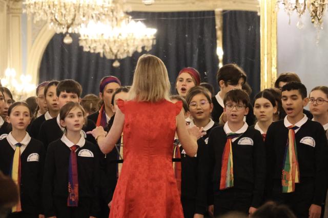 (260224) -- PARIS, Feb. 24, 2026 (Xinhua) -- Children perform during a concert at the 20th arrondissement town hall in Paris, France, on Feb. 14, 2026. TO GO WITH "Roundup: Future-oriented Chinese New Year in France blends tradition, technology" (Xinhua/Zhang Baihui)