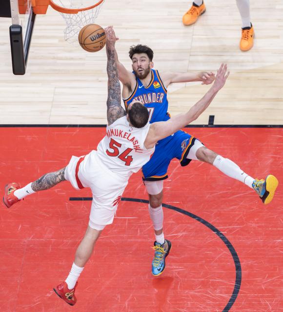 (260225) -- TORONTO, Feb. 25, 2026 (Xinhua) -- Chet Holmgren (back) of Oklahoma City Thunder blocks Sandro Mamukelashvili of Toronto Raptors during the 2025-2026 NBA regular season game between Toronto Raptors and Oklahoma City Thunder in Toronto, Canada, on Feb. 24, 2026. (Photo by Zou Zheng/Xinhua)