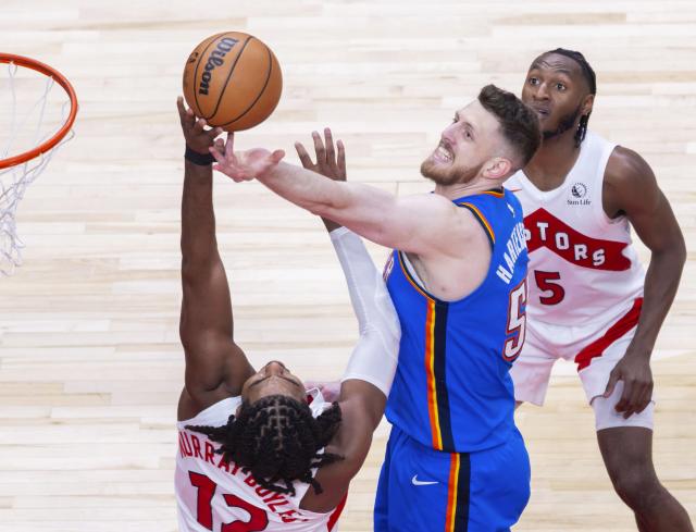 (260225) -- TORONTO, Feb. 25, 2026 (Xinhua) -- Collin Murray-Boyles (L) of Toronto Raptors fights for a rebound with Isaiah Hartenstein (C) of Oklahoma City Thunder during the 2025-2026 NBA regular season game between Toronto Raptors and Oklahoma City Thunder in Toronto, Canada, on Feb. 24, 2026. (Photo by Zou Zheng/Xinhua)