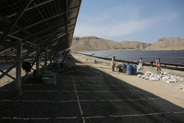 (260225) -- KABUL, Feb. 25, 2026 (Xinhua) -- Workers check solar panels at a solar power plant in Surobi district of Kabul, Afghanistan, Feb. 17, 2026. TO GO WITH "Feature: Afghanistan seeks solar-driven path to energy self-sufficiency" (Photo by Saifurahman Safi/Xinhua)