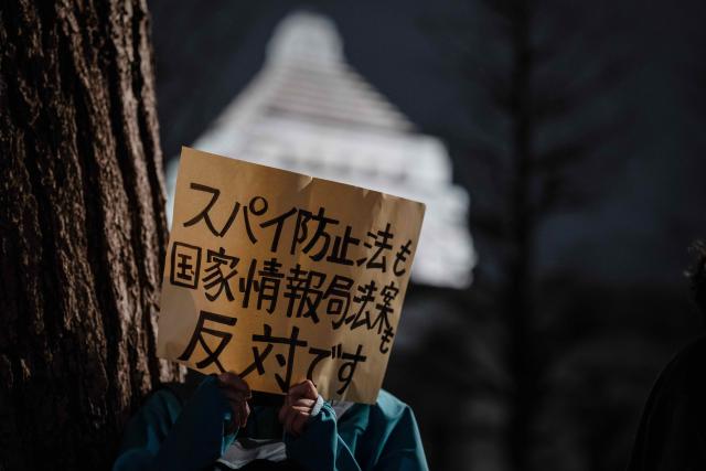 (260225) -- TOKYO, Feb. 25, 2026 (Xinhua) -- A person holding a sign attends a rally in front of the Second Members' Office Building of the House of Representatives in Tokyo, Japan, Feb. 24, 2026. A large crowd of Japanese people gathered Tuesday evening in Tokyo to protest Prime Minister Sanae Takaichi's dangerous push for policies including accelerating constitutional revision, expanding military capabilities and strengthening national intelligence functions, voicing concerns about the country's future direction. (Xinhua/Jia Haocheng)