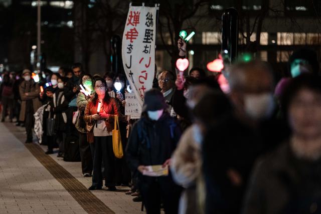 (260225) -- TOKYO, Feb. 25, 2026 (Xinhua) -- People attend a rally in front of the Second Members' Office Building of the House of Representatives in Tokyo, Japan, Feb. 24, 2026. A large crowd of Japanese people gathered Tuesday evening in Tokyo to protest Prime Minister Sanae Takaichi's dangerous push for policies including accelerating constitutional revision, expanding military capabilities and strengthening national intelligence functions, voicing concerns about the country's future direction. (Xinhua/Jia Haocheng)