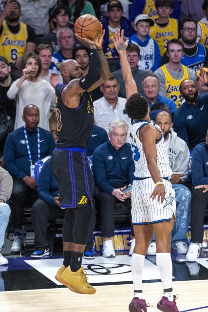 (260225) -- LOS ANGELES, Feb. 25, 2026 (Xinhua) -- Los Angeles Lakers' LeBron James (L) shoots against Orlando Magic's Tristan da Silva during the 2025-2026 NBA regular season basketball game between Los Angeles Lakers and Orlando Magic in Los Angeles, the United States, Feb. 24, 2026. (Photo by Ringo Chiu/Xinhua)