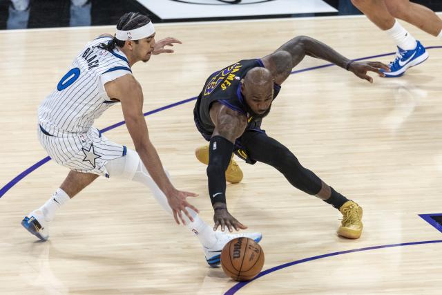 (260225) -- LOS ANGELES, Feb. 25, 2026 (Xinhua) -- Los Angeles Lakers' LeBron James (R) and Orlando Magic's Anthony Black vie for the ball during the 2025-2026 NBA regular season basketball game between Los Angeles Lakers and Orlando Magic in Los Angeles, the United States, Feb. 24, 2026. (Photo by Ringo Chiu/Xinhua)