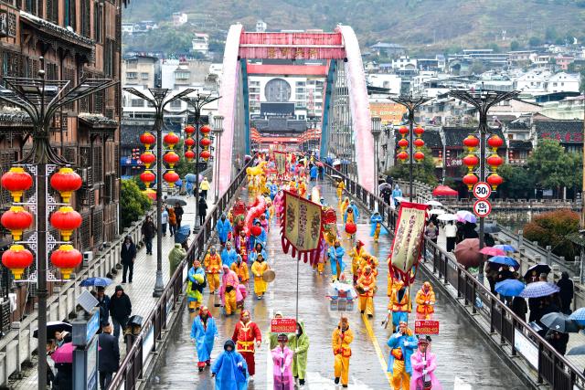 (260227) -- SHIQIAN, Feb. 27, 2026 (Xinhua) -- People attend a parade during the "Maolong Festival" of Yilao ethnic group in Shiqian County, southwest China's Guizhou Province, Feb. 27, 2026. The Maolong Festival, a folk activity for people of the Yilao ethnic group to mark the Spring Festival and the lantern festival, was listed as a national intangible cultural heritage in 2006. The centerpiece of this festival is the Maolong, or "hairy dragon," found only in Shiqian. (Xinhua/Yang Wenbin)