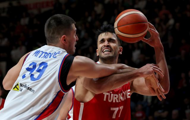 (260228) -- BELGRADE, Feb. 28, 2026 (Xinhua) -- Türkiye's Omer Yurtseven (R) vies with Serbia's Luka Mitrovic during the first round group C match between Serbia and Türkiye at the FIBA Basketball World Cup 2027 European Qualifiers in Belgrade, Serbia, on Feb. 27, 2026. (Photo by Predrag Milosavljevic/Xinhua)