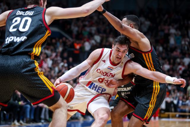 (260227) -- Zagreb, Feb. 27 2026 (Xiunhua) -- Mario Hezonja (C) of Croatia breaks through during the first round group E match between Croatia and Germany at the FIBA Basketball World Cup 2027 European Qualifiers in Zagreb, Croatia, on Feb. 27, 2026. (Igor Kralj/PIXSELL via Xinhua)