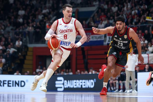 (260227) -- Zagreb, Feb. 27 2026 (Xiunhua) -- Mario Hezonja (L) of Croatia dribbles past Kostja Mushidi of Germany during the first round group E match between Croatia and Germany at the FIBA Basketball World Cup 2027 European Qualifiers in Zagreb, Croatia, on Feb. 27, 2026. (Igor Kralj/PIXSELL via Xinhua)