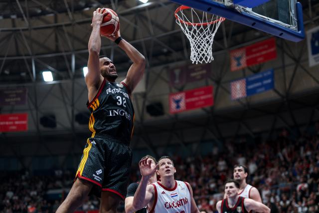 (260227) -- Zagreb, Feb. 27 2026 (Xiunhua) -- Johannes Thiemann (top) of Germany dunks during the first round group E match between Croatia and Germany at the FIBA Basketball World Cup 2027 European Qualifiers in Zagreb, Croatia, on Feb. 27, 2026. (Igor Kralj/PIXSELL via Xinhua)