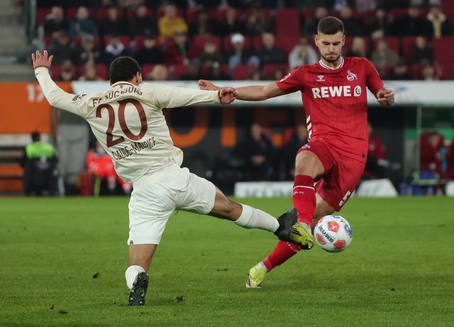 (260228) -- AUGSBURG, Feb. 28, 2026 (Xinhua) -- Alexis Claude Maurice (L) of FC Augsburg vies with Tom Krauss of FC Cologne during the German first division Bundesliga football match between FC Augsburg and FC Cologne in Augsburg, Germany, Feb. 27, 2026. (Photo by Philippe Ruiz/Xinhua)