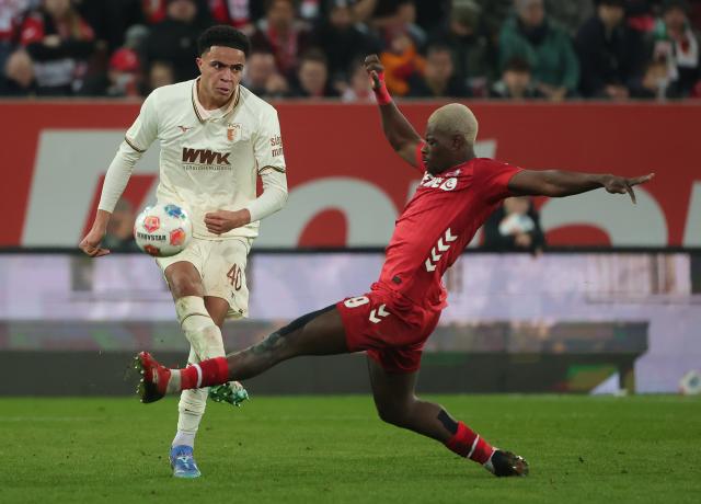 (260228) -- AUGSBURG, Feb. 28, 2026 (Xinhua) -- Noahkai Banks (L) of FC Augsburg vies with Ragnar Ache of FC Cologne during the German first division Bundesliga football match between FC Augsburg and FC Cologne in Augsburg, Germany, Feb. 27, 2026. (Photo by Philippe Ruiz/Xinhua)