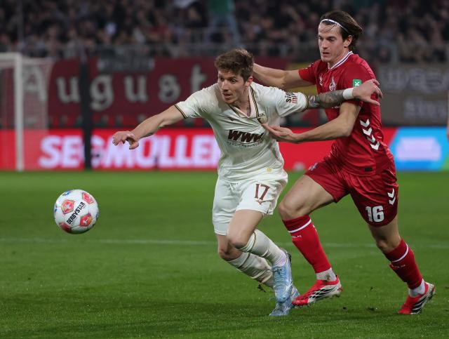 (260228) -- AUGSBURG, Feb. 28, 2026 (Xinhua) -- Kristijan Jakic (L) of FC Augsburg vies with Jakub Kaminski of FC Cologne during the German first division Bundesliga football match between FC Augsburg and FC Cologne in Augsburg, Germany, Feb. 27, 2026. (Photo by Philippe Ruiz/Xinhua)