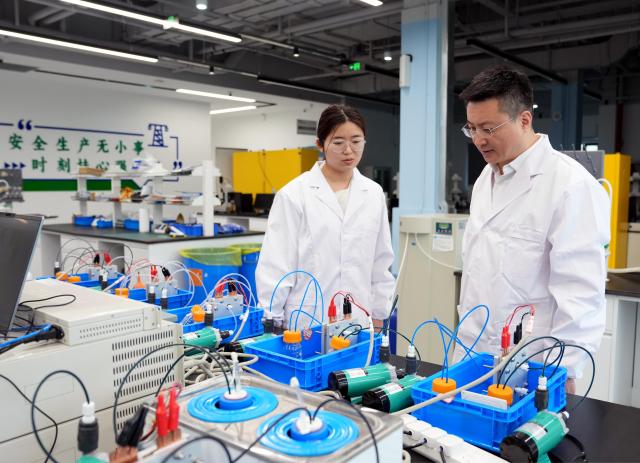 (260228) -- SHANGHAI, Feb. 28, 2026 (Xinhua) -- Zhang Fan (R) communicates with an engineer at a research base of China Electrical Equipment Group in Shanghai, east China, Jan. 27, 2026.
  Zhang Fan is vice general manager of China Electrical Equipment Group and a deputy to the National People's Congress (NPC). Zhang believes that "artificial intelligence (AI) plus manufacturing" would be achieved through strengthening top-level design and industry guidelines. Last year, Zhang presented a suggestion on deepening integration of manufacturing and AI to promote high-quality innovative development. His suggestion was given great importance. 
  In January 2026, eight departments of China including the Ministry of Industry and Information Technology jointly issued a plan which outlines an ambitious push to deeply integrate AI with the manufacturing sector, foster new quality productive forces and comprehensively empower new industrialization.
  Zhang stated that he will continue to concentrate on issues about the bottlenecks of data sharing in AI-driven manufacturing sector and successful experiences of leading enterprises. (Xinhua/Liu Ying)