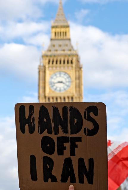 (260301) -- LONDON, March 1, 2026 (Xinhua) -- A man holds a placard during a protest against U.S.-Israeli attacks on Iran, at the Parliament Square in central London, Britain, on Feb. 28, 2026. The United States and Israel on Saturday launched "major combat operations" against Iran, plunging the war-torn Middle East into a new round of violent conflicts.
   Iran has retaliated with a series of counterattacks against Israel and U.S. targets across the region, with explosions reported in Bahrain, Qatar, Kuwait, Jordan, the United Arab Emirates (UAE), and Saudi Arabia, among other countries. (Xinhua/Li Ying)