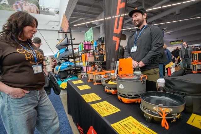 (260301) -- VANCOUVER, March 1, 2026 (Xinhua) -- A woman checks out camping cooking gear at the 2026 Outdoor Adventure and Travel Show in Vancouver, British Columbia, Canada, on Feb. 28, 2026. The two-day annual event kicked off Saturday, with over 250 exhibitors showcasing the latest developments in camping gear, paddle sports equipment, outdoor clothing, scuba diving gear, and adventure travel experiences. (Photo by Liang Sen/Xinhua)