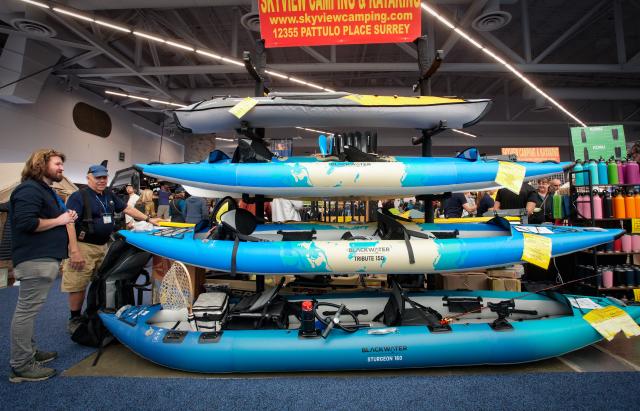 (260301) -- VANCOUVER, March 1, 2026 (Xinhua) -- Visitors check out inflatable kayaks at the 2026 Outdoor Adventure and Travel Show in Vancouver, British Columbia, Canada, on Feb. 28, 2026. The two-day annual event kicked off Saturday, with over 250 exhibitors showcasing the latest developments in camping gear, paddle sports equipment, outdoor clothing, scuba diving gear, and adventure travel experiences. (Photo by Liang Sen/Xinhua)