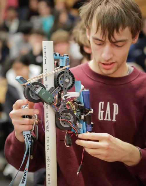 (260301) -- VANCOUVER, March 1, 2026 (Xinhua) -- A student fine-tunes a robotic pole climber during the 48th annual Physics Olympics at the University of British Columbia in Vancouver, British Columbia, Canada, on Feb. 28, 2026. More than 1,000 high school students from across the Canadian province of British Columbia participated in the 48th annual Physics Olympics held here on Saturday. (Photo by Liang Sen/Xinhua)