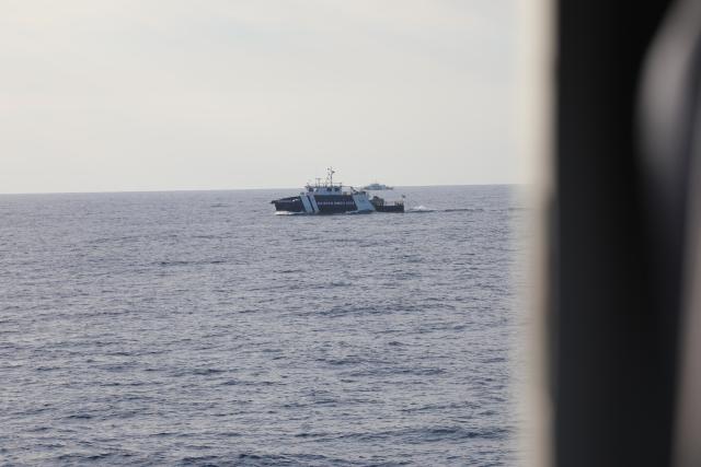 (260301) -- SOUTH CHINA SEA, March 1, 2026 (Xinhua) -- Two Philippine vessels sail near China Coast Guard (CCG) vessels in waters off China's Huangyan Dao in the South China Sea, Feb. 27, 2026. The CCG on Friday drove away Philippine vessels that illegally intruded into China's territorial waters off Huangyan Dao in the South China Sea. (CCG/Handout via Xinhua)