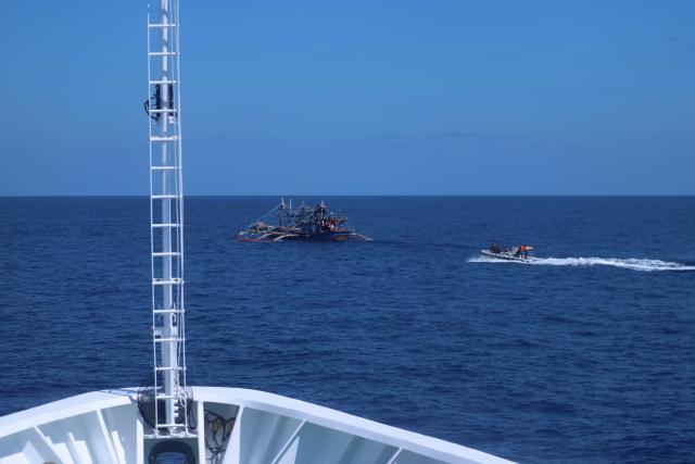 (260301) -- SOUTH CHINA SEA, March 1, 2026 (Xinhua) -- A law enforcement boat of China Coast Guard (CCG) vessel Wanshan lawfully expels a Philippine fishing boat in waters off China's Huangyan Dao in the South China Sea, Feb. 27, 2026. The CCG on Friday drove away Philippine vessels that illegally intruded into China's territorial waters off Huangyan Dao in the South China Sea. (CCG/Handout via Xinhua)