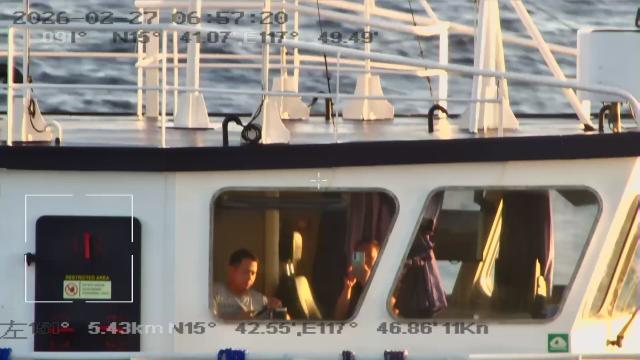 (260301) -- SOUTH CHINA SEA, March 1, 2026 (Xinhua) -- Crew members of a Philippine vessel film China Coast Guard (CCG) vessels and law enforcers in waters off China's Huangyan Dao in the South China Sea, Feb. 27, 2026. The CCG on Friday drove away Philippine vessels that illegally intruded into China's territorial waters off Huangyan Dao in the South China Sea. (CCG/Handout via Xinhua)
