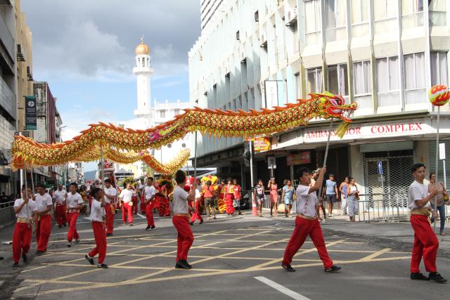 (260301) -- PORT LOUIS, March 1, 2026 (Xinhua) -- A dragon and lion dance is staged during a float parade marking the Spring Festival in Port Louis, Mauritius, Feb. 28, 2026. The parade, jointly organized by the Chinese Embassy in Mauritius, the China Cultural Center in Mauritius, the Municipality of Port Louis and the United Chinese Associations, was held in a festive and sharing atmosphere in Port Louis on Saturday. (Photo by Ally Soobye/Xinhua)