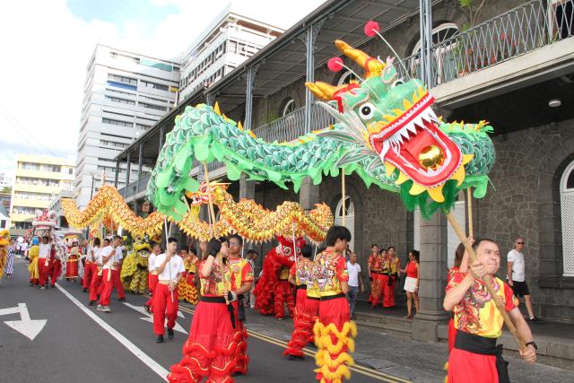 (260301) -- PORT LOUIS, March 1, 2026 (Xinhua) -- A dragon and lion dance is staged during a float parade marking the Spring Festival in Port Louis, Mauritius, Feb. 28, 2026. The parade, jointly organized by the Chinese Embassy in Mauritius, the China Cultural Center in Mauritius, the Municipality of Port Louis and the United Chinese Associations, was held in a festive and sharing atmosphere in Port Louis on Saturday. (Photo by Ally Soobye/Xinhua)