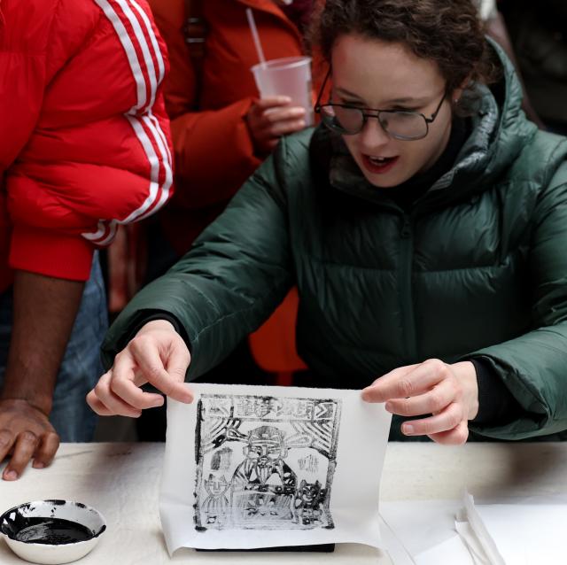 (260301) -- LONDON, March 1, 2026 (Xinhua) -- A woman tries to make a piece of Chinese traditional woodblock print known as Jiama during an event in celebration of the upcoming Lantern Festival in London, Britain, Feb. 28, 2026. (Xinhua/Li Ying)