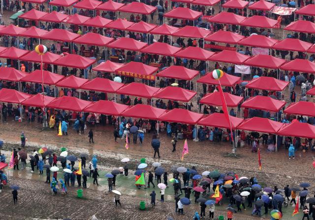 (260301) -- BAOFENG, March 1, 2026 (Xinhua) -- An aerial drone photo shows a view at the Majie Quyi Fair at Majie Village of Baofeng County, central China's Henan Province, March 1, 2026.
  The annual Majie Quyi Fair, a grand feast for Quyi fans, was staged as scheduled here on Sunday, as part of the ongoing Chinese New Year celebrations. 
   Quyi refers to a school of traditional Chinese folk arts in narrative and singing forms, including ballad singing, comic dialogues, clapper talk and crosstalk, still popular among the Chinese people.
    The Majie Quyi Fair, well attended despite the bad weather, boasts a history of over 700 years, and was inscribed in the first national intangible cultural heritage list in 2006. (Xinhua/Li Jianan)