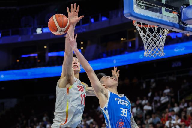 (260301) -- PASAY CITY, March 1, 2026 (Xinhua) -- Yu Jiahao (L) of China blocks the shot of Justin Lu (R) of Chinese Taipei during the match between China and Chinese Taipei at the FIBA World Cup Asian Qualifiers in Pasay City, the Philippines, on March 1, 2026. (Xinhua/Rouelle Umali)