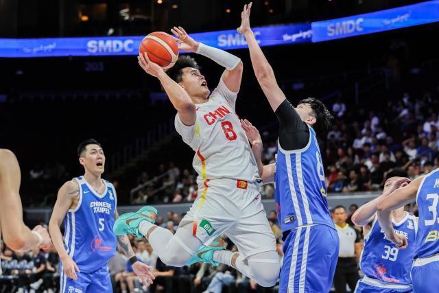 (260301) -- PASAY CITY, March 1, 2026 (Xinhua) -- Zhao Rui (C) of China competes during the match between China and Chinese Taipei at the FIBA World Cup Asian Qualifiers in Pasay City, the Philippines, on March 1, 2026. (Xinhua/Rouelle Umali)