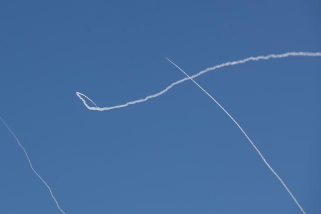 (260301) -- TEL AVIV, March 1, 2026 (Xinhua) -- This photo taken on March 1, 2026 shows smoke trails left by interceptor missiles launched from Israeli air defense systems in downtown Tel Aviv, Israel. Multiple explosions were heard in Tel Aviv on Sunday, eyewitnesses said, as Israel's military said it was operating to intercept new barrages of missiles from Iran that triggered air raid sirens across the country. (Xinhua/Chen Junqing)