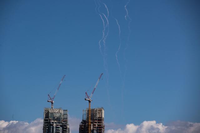 (260301) -- TEL AVIV, March 1, 2026 (Xinhua) -- This photo taken on March 1, 2026 shows smoke trails left by interceptor missiles launched from Israeli air defense systems in downtown Tel Aviv, Israel. Multiple explosions were heard in Tel Aviv on Sunday, eyewitnesses said, as Israel's military said it was operating to intercept new barrages of missiles from Iran that triggered air raid sirens across the country. (Xinhua/Chen Junqing)