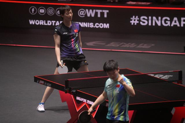 (260301) -- SINGAPORE, March 1, 2026 (Xinhua) -- Wang Manyu (L) of China reacts during the women's singles final between Sun Yingsha of China and Wang Manyu of China at the World Table Tennis (WTT) Singapore Smash 2026 in Singapore on March 1, 2026. (Photo by Then Chih Wey/Xinhua)