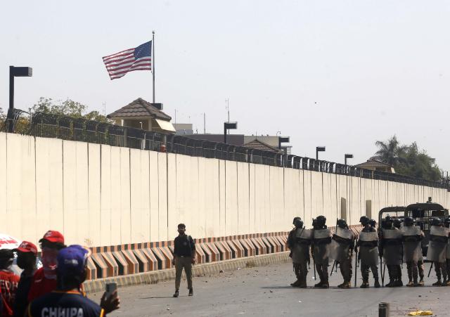 (260302) -- KARACHI, March 2, 2026 (Xinhua) -- Law enforcement personnel (R) stand guard during clashes with anti-U.S. protesters near the U.S. Consulate in southern Pakistani port city of Karachi on March 1, 2026. Twenty people were killed and over 100 others injured in anti-U.S. demonstrations in Pakistan on Sunday, police sources told Xinhua. (Photo by Imran Ali/Xinhua)