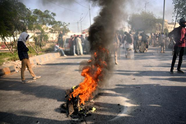 (260302) -- KARACHI, March 2, 2026 (Xinhua) -- Anti-U.S. protesters clash with law enforcement personnel near the U.S. Consulate in southern Pakistani port city of Karachi on March 1, 2026. Twenty people were killed and over 100 others injured in anti-U.S. demonstrations in Pakistan on Sunday, police sources told Xinhua. (Photo by Imran Ali/Xinhua)