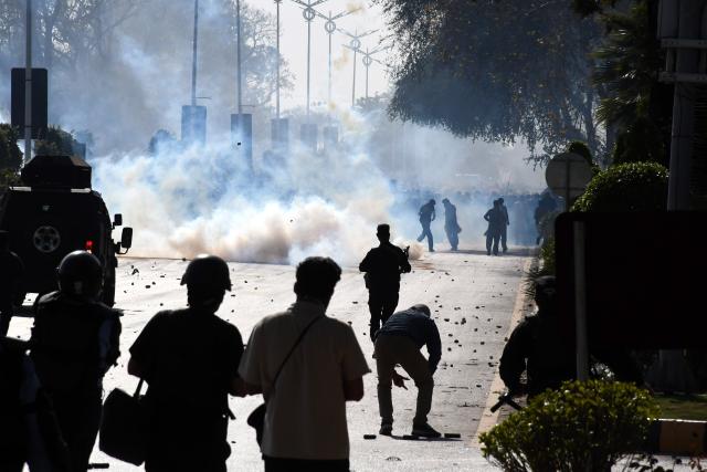 (260302) -- ISLAMABAD, March 2, 2026 (Xinhua) -- Law enforcement personnel clash with anti-U.S. protesters in Islamabad, capital of Pakistan, March 1, 2026. Twenty people were killed and over 100 others injured in anti-U.S. demonstrations in Pakistan on Sunday, police sources told Xinhua. (Xinhua)
