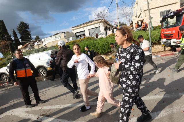 (260302) -- JERUSALEM, March 2, 2026 (Xinhua) -- Residents evacuate from the site of a missile strike in Beit Shemesh, west of Jerusalem, March 1, 2026. Eight people were killed and at least 23 were injured on Sunday when an Iranian missile struck a residential area in Beit Shemesh, west of Jerusalem, according to local media reports. (Photo by Gil Cohen Magen/Xinhua)