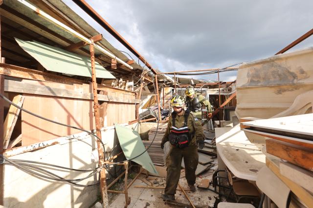 (260302) -- JERUSALEM, March 2, 2026 (Xinhua) -- Rescuers work at the site of a missile strike in Beit Shemesh, west of Jerusalem, March 1, 2026. Eight people were killed and at least 23 were injured on Sunday when an Iranian missile struck a residential area in Beit Shemesh, west of Jerusalem, according to local media reports. (Photo by Gil Cohen Magen/Xinhua)