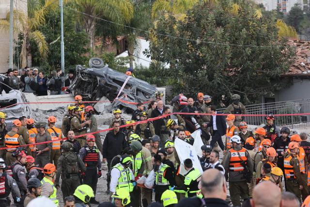 (260302) -- JERUSALEM, March 2, 2026 (Xinhua) -- Rescuers work at the site of a missile strike in Beit Shemesh, west of Jerusalem, March 1, 2026. Eight people were killed and at least 23 were injured on Sunday when an Iranian missile struck a residential area in Beit Shemesh, west of Jerusalem, according to local media reports. (Photo by Gil Cohen Magen/Xinhua)