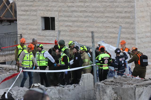 (260302) -- JERUSALEM, March 2, 2026 (Xinhua) -- Rescuers work at the site of a missile strike in Beit Shemesh, west of Jerusalem, March 1, 2026. Eight people were killed and at least 23 were injured on Sunday when an Iranian missile struck a residential area in Beit Shemesh, west of Jerusalem, according to local media reports. (Photo by Gil Cohen Magen/Xinhua)