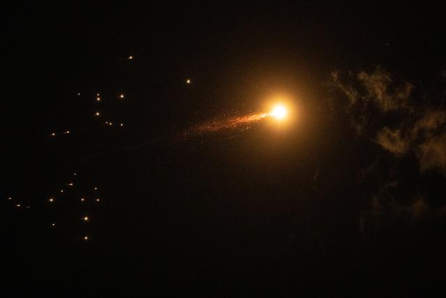 (260302) -- TEL AVIV, March 2, 2026 (Xinhua) -- Missile debris falls after Israeli air defense systems launched interceptor missiles over Tel Aviv, Israel, March 1, 2026. Multiple explosions were heard in Tel Aviv on Sunday, eyewitnesses said, as Israel's military said it was operating to intercept new barrages of missiles from Iran that triggered air raid sirens across the country. (Xinhua/Chen Junqing)