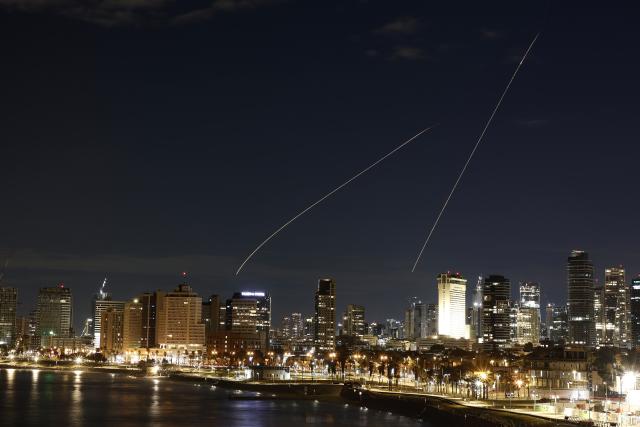 (260302) -- TEL AVIV, March 2, 2026 (Xinhua) -- This long exposure photo taken on March 1, 2026 shows flare trails left by interceptor missiles launched from Israeli air defense systems in Tel Aviv, Israel. Multiple explosions were heard in Tel Aviv on Sunday, eyewitnesses said, as Israel's military said it was operating to intercept new barrages of missiles from Iran that triggered air raid sirens across the country. (Photo by Jamal Awad/Xinhua)