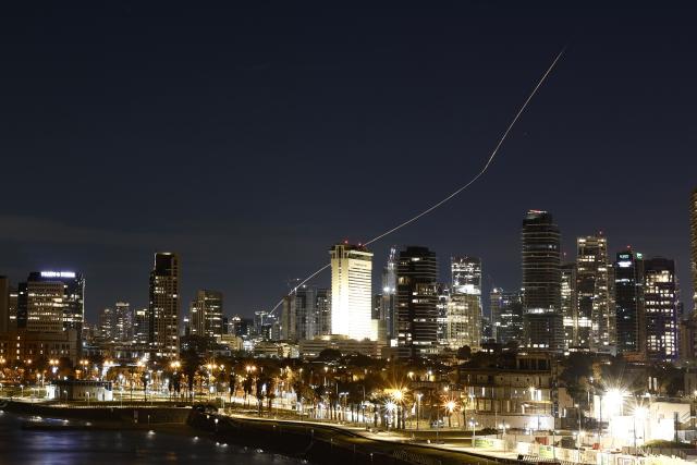 (260302) -- TEL AVIV, March 2, 2026 (Xinhua) -- This long exposure photo taken on March 1, 2026 shows a flare trail left by interceptor missiles launched from Israeli air defense systems in Tel Aviv, Israel. Multiple explosions were heard in Tel Aviv on Sunday, eyewitnesses said, as Israel's military said it was operating to intercept new barrages of missiles from Iran that triggered air raid sirens across the country. (Photo by Jamal Awad/Xinhua)