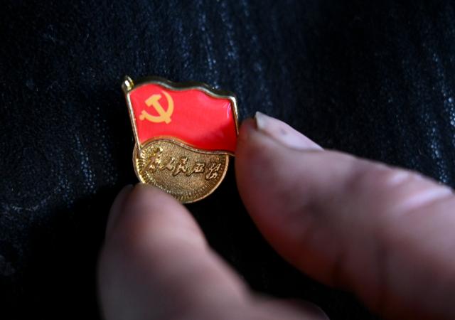 (260301) -- XINYUAN, March 1, 2026 (Xinhua) -- Musajan Khairat wears a Party emblem at his home before going to the community service center in Keregetas Village, Xinyuan County of Ili Kazak Autonomous Prefecture, northwest China's Xinjiang Uygur Autonomous Region, Feb. 9, 2026.
  Musajan Khaira, a villager of Keregetas Village of Xinyuan County, is a deputy to the National People's Congress (NPC). After graduating from junior high school, he learned blacksmithing and welding skills and runs a welding workshop. In addition to pursuing a better life for his own family, Musajan also taught welding skills to villagers for free, helping local people to increase their incomes.
  As an NPC deputy, Musajan consistently focuses on the demands of local people. In response to villagers' concerns about difficulties in farmland irrigation and road accessibility, he presented a suggestion on construction of high-standard farmland at a ravine area in Xinyuan County. With his efforts, a high-standard farmland construction project was launched and drip irrigation facilities were promoted, making it easier for farmers to cultivate the land and ensuring more stable income growth.
  Musajan keeps concentrating on high-quality development of rural areas. He presented suggestions such as advancing the reconstruction and expansion of local airport, upgrading county roads, and protecting wetland ecosystems, to promote rural development and improve local people's well-being. (Xinhua/Wang Fei)