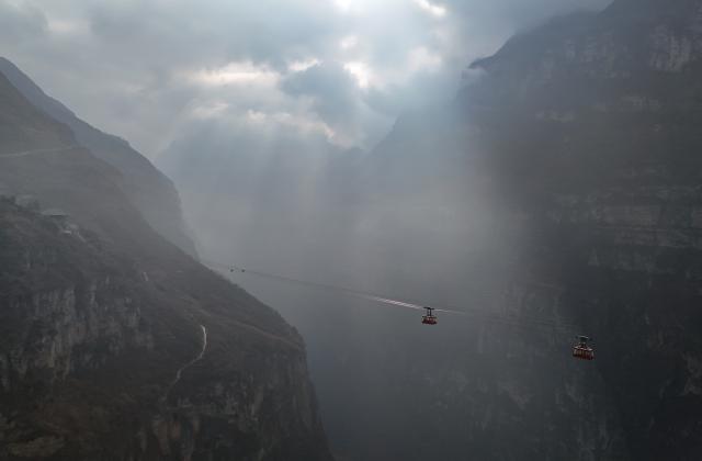 (260302) -- HANYUAN, March 2, 2026 (Xinhua) -- An aerial drone photo taken on Jan. 29, 2026 shows a view of the cableway in Gulu Village of Hanyuan County, southwest China's Sichuan Province.
  Perched on a cliff at the entrance to the Dadu River Grand Canyon, Gulu Village in Sichuan Province was long isolated by poor transportation. The opening of a cableway in 2018 marked a turning point, cutting the journey from three to four hours down to just three to five minutes. 
  Zheng Wangchun is the head of the village committee and secretary of the Party committee of Gulu Village, and a deputy to the National People's Congress (NPC). Over the past years, Zheng has led villagers in developing a new path of integrated agricultural, cultural and tourism development, breathing new life into this Yi ethnic village. Villagers have opened homestays for visitors, and multiple scenic photo spots to enhance the visitor experience. At the same time, the village has expanded characteristic industries such as walnuts, Sichuan pepper, and goat farming. 
  Since taking office, Zheng has submitted suggestions including expanding internet access in rural areas and strengthening wildlife protection while minimizing its impact on farmers' livelihoods. "The smiles of villagers are the most valuable rewards for grassroots work," Zheng said. (Xinhua/Wang Xi)