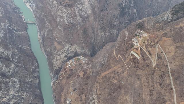 (260302) -- HANYUAN, March 2, 2026 (Xinhua) -- An aerial drone photo taken on Jan. 29, 2026 shows a view of Gulu Village of Hanyuan County, southwest China's Sichuan Province.
  Perched on a cliff at the entrance to the Dadu River Grand Canyon, Gulu Village in Sichuan Province was long isolated by poor transportation. The opening of a cableway in 2018 marked a turning point, cutting the journey from three to four hours down to just three to five minutes. 
  Zheng Wangchun is the head of the village committee and secretary of the Party committee of Gulu Village, and a deputy to the National People's Congress (NPC). Over the past years, Zheng has led villagers in developing a new path of integrated agricultural, cultural and tourism development, breathing new life into this Yi ethnic village. Villagers have opened homestays for visitors, and multiple scenic photo spots to enhance the visitor experience. At the same time, the village has expanded characteristic industries such as walnuts, Sichuan pepper, and goat farming. 
  Since taking office, Zheng has submitted suggestions including expanding internet access in rural areas and strengthening wildlife protection while minimizing its impact on farmers' livelihoods. "The smiles of villagers are the most valuable rewards for grassroots work," Zheng said. (Xinhua/Wang Xi)