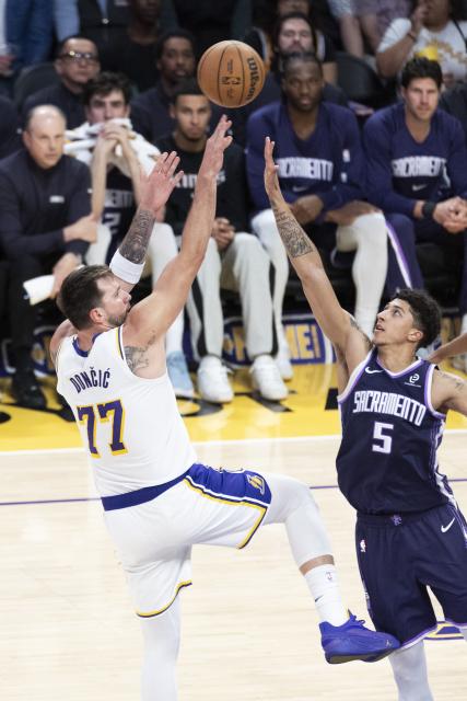 (260302) -- LOS ANGELES, March 2, 2026 (Xinhua) -- Los Angeles Lakers' Luka Doncic (L) shoots against Sacramento Kings' Nique Clifford during the 2025-2026 NBA regular season basketball game between Los Angeles Lakers and Sacramento Kings in Los Angeles, the United States, March 1, 2026. (Photo by Ringo Chiu/Xinhua)