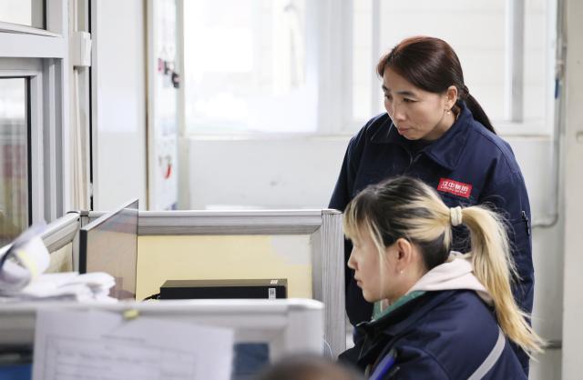 (260302) -- TIANJIN, March 2, 2026 (Xinhua) -- Guo Hongjing (back) talks with her colleague at Tianjin Lizhong Wheel Co., Ltd. in north China's Tianjin, Feb. 25, 2026.
  Guo Hongjing works as the head of a hardware parts team in the warehousing department of Tianjin Lizhong Wheel Co., Ltd. Her daily work involves receiving, dispatching, and checking materials in the warehouse. This seemingly trivial job is far from easy. From screws to motors, across all types and models, she  must keep every item in the warehouse firmly in mind.
  Since 2018, Guo has served as a deputy to the National People's Congress (NPC) for two consecutive terms, during which she is concerned most about her fellow workers. She listens to the voices of front-line workers and collects their opinions and suggestions as much as she can. 
  During her tenure, Guo has visited enterprises for research and surveys, with her focus on the upgrading of manufacturing industry and the transformation of industrial workers. She has also put forward proposals on issues such as rural elderly care and privacy concerns related to courier waybill information leaks.
  At this year's "two sessions," Guo will put emphasis on topics including the green development of industries, the protection of workers' rights, and the implementation of paid leave policies. (Xinhua/Li Ran)