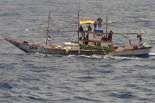 (260302) -- SOUTH CHINA SEA, March 2, 2026 (Xinhua) -- An unidentified man, whose clothing and physique is markedly different from those of ordinary Philippine fishermen, is seen aboard a Philippine fishing boat in waters off China's Huangyan Dao in the South China Sea, Feb. 21, 2026.
  The Philippine side has in recent days repeatedly directed its coast guard and official vessels to organize fishing boats for intrusions into the territorial waters off China's Huangyan Dao in the South China Sea.
  Under the guise of "escort" and "rights protection," these actions were staged for publicity stunts, infringing upon China's sovereignty and maritime rights and interests.
  TO GO WITH "Explainer: A closer look at Philippine provocations off China's Huangyan Dao" (China Coast Guard/Handout via Xinhua)